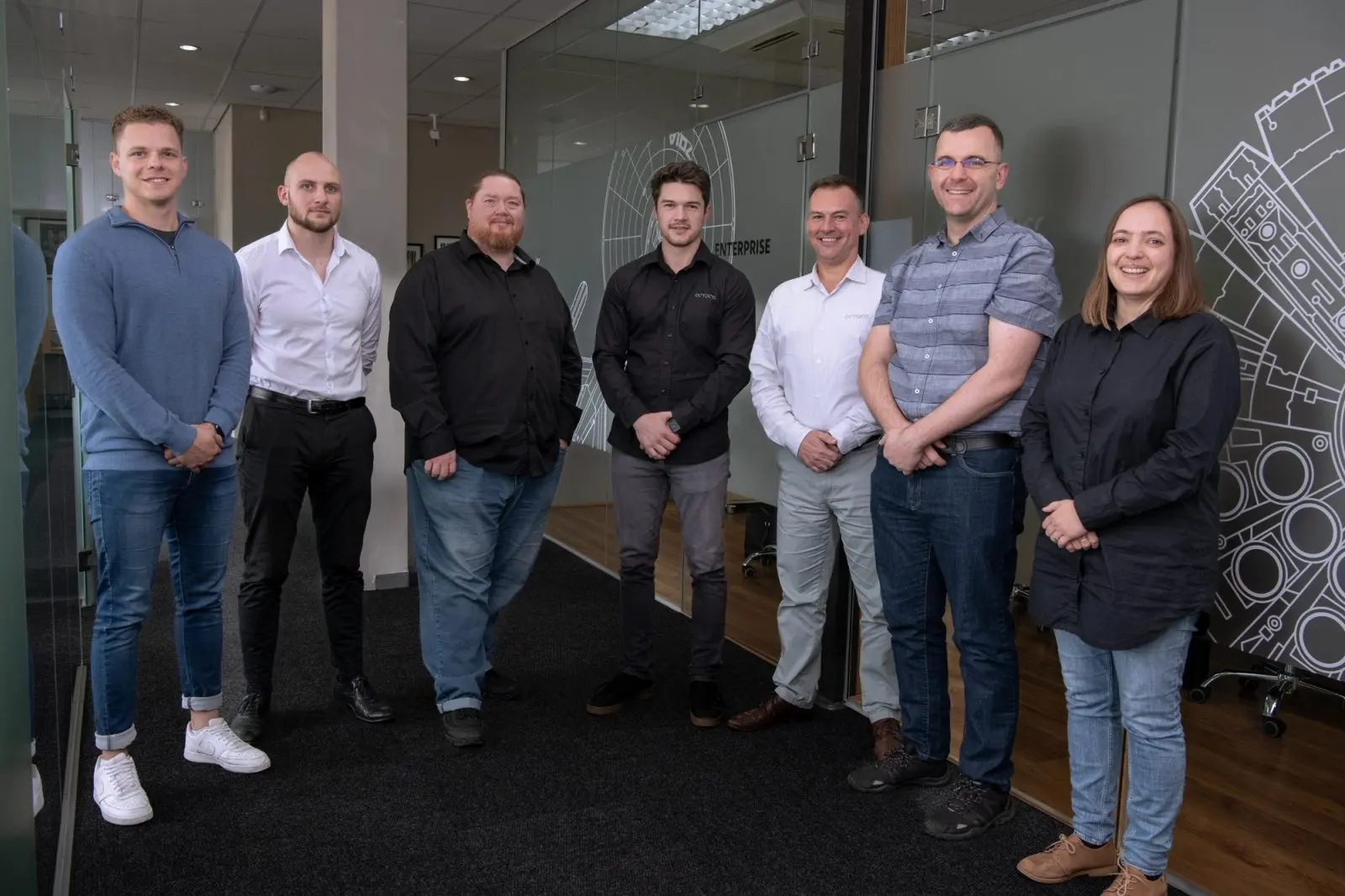 The Polymorph and Octoco teams standing together in the Polymorph office