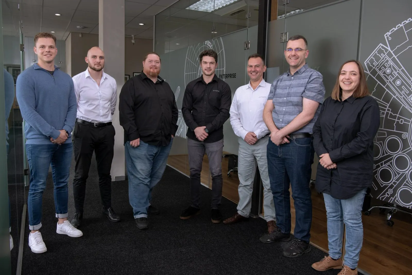 The Polymorph and Octoco teams standing together in the Polymorph office
