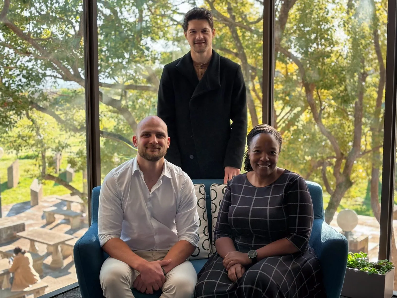 The Squirrel Away founders with the Yenza team, seated on a couch in front of a window