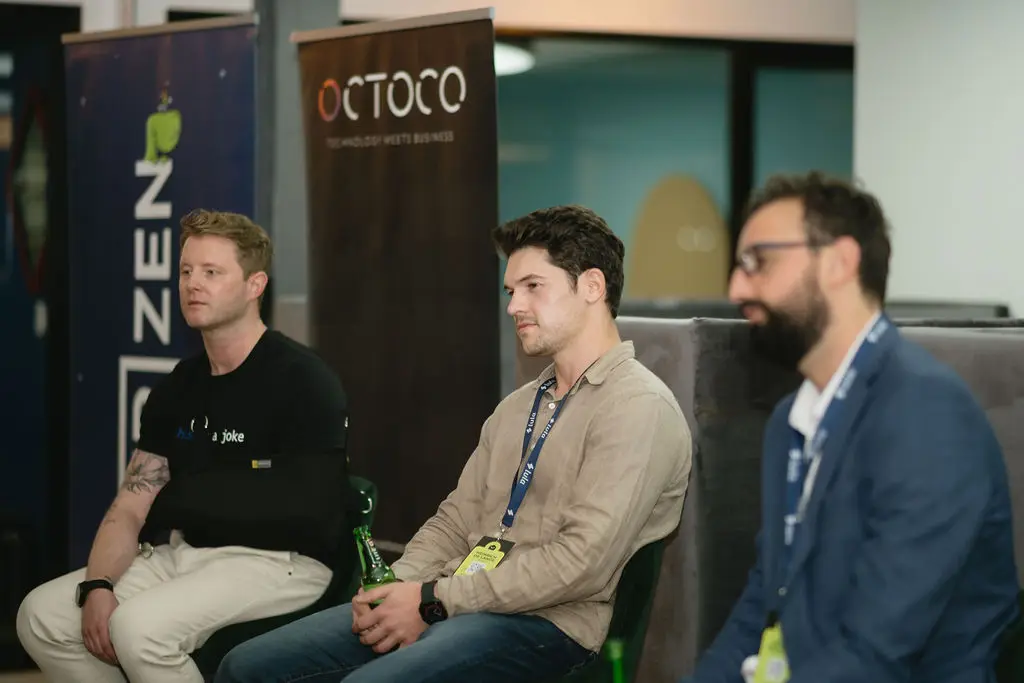 Three panellists seated in front of Zen and Octoco banners at a founders’ event